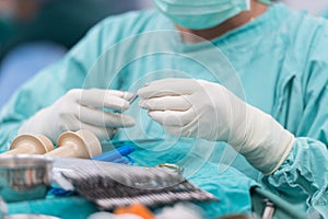 Scrub nurse preparing tools for open heart surgery