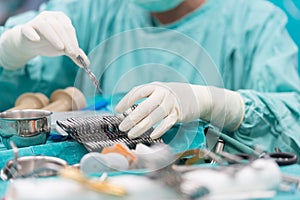 Scrub nurse preparing tools for open heart surgery