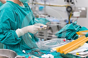 Scrub nurse preparing tools for open heart surgery