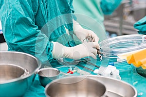 Scrub nurse preparing tools for operation