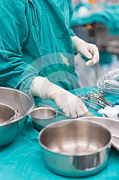 Scrub nurse preparing tools for operation