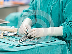 Scrub nurse preparing tools for operation