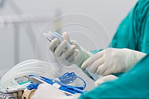 Scrub nurse preparing tools for operation