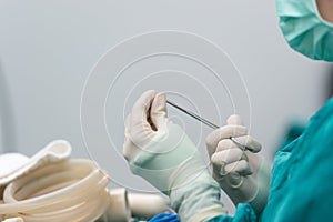 Scrub nurse preparing tools for operation
