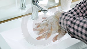 Scrubbing hands, washing away dirt,body hygiene,a man observes cleanliness of the body,close-up.