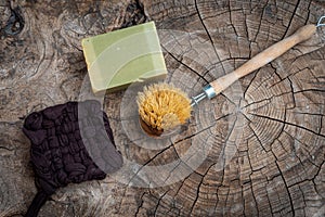 Scrubbung brush with olive oil soap ,aleppo or alep soap  & and handmade tawashi,on wooden table ,zero waste