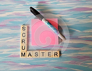 Scrum Master in letters with pink notes and blue background photo