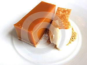 Scrumptious dessert: golden orange on a white plate