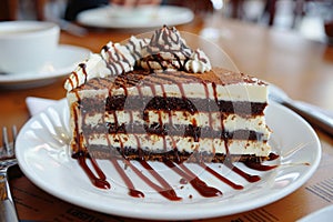 Scrumptious Multi-layered Chocolate Cake with White Frosting and Drizzled Chocolate Sauce photo