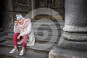 Serious mature woman sightseeing in town photo