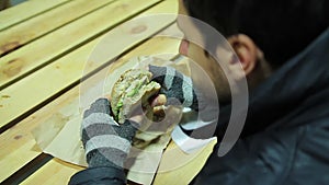 Scrupulous worker eating sandwich with vegetables and cheese. Healthy food