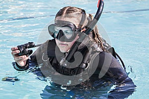 Scuba dive training in a pool, a student with a wetsuit