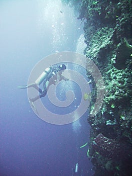 Scuba diver against cliff