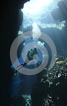 Scuba Diver in a cave with sunbeams photo