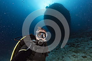 Scuba diver diving Ship Wreck in maldives indian ocean