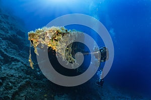 A scuba diver explores an sunken shipwreck in the Aegean Sea