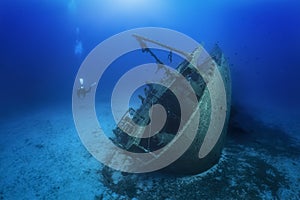 A scuba diver explores a sunken shipwreck