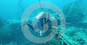 Scuba Diver Exploring Big Japanese Ship Wreck. The ship was sunk during World War II