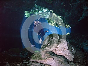 A SCUBA Diver Fins Through a Yucatan Cenote