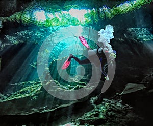 A Scuba Diver Follows a Guideline in a Mexican Cenote photo