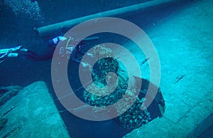 Scuba diver and huge propeller of an old schipwreck