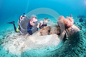 Scuba diver photographing corals