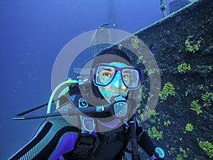 Scuba Diver Portrait Beside Large Shipwreck
