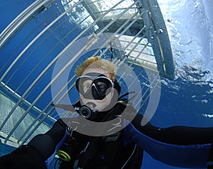 Scuba diver with shark cage