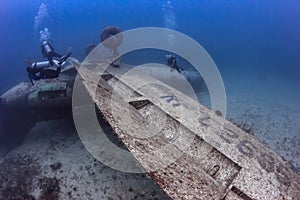 SCUBA divers explore the wreck of an aircraft