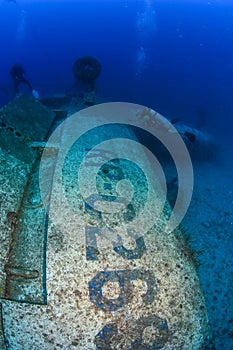 SCUBA divers explore the wreck of an aircraft