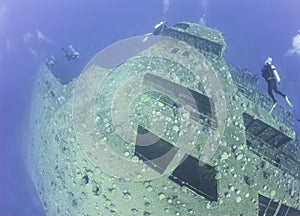 Scuba divers exploring a shipwreck