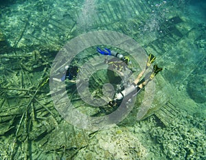 Scuba divers exploring an underwater wreck