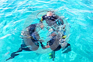 Scuba divers are submerged under water.