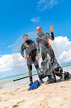 Scuba divers in a suit for diving having fun
