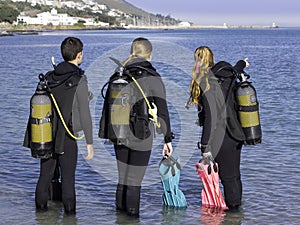 Scuba divers in training on the beach planning their dive