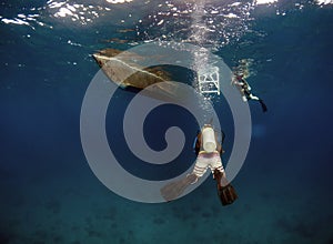Scuba divers underwater in the clear waters of El Nido in Palawan