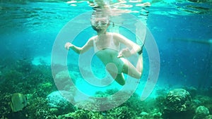 Scuba diving, adventure and woman swimming underwater at the beach while on a seaside vacation. Travel, freedom and girl