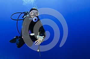 Scuba diving in clear blue water photo