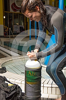 Scuba diving course pool teenager girl with instructor