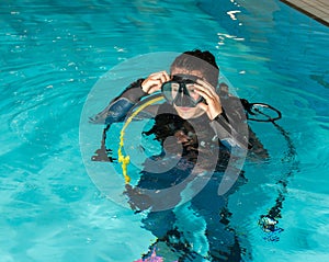 Scuba diving course pool teenager girl with instructor in the pool