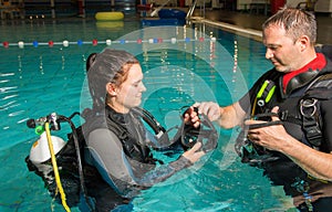 Scuba diving course pool teenager girl with instructor in the water