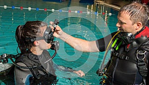 Scuba diving course pool teenager girl with instructor in the water