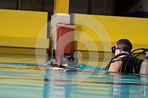 Scuba diving course pool teenager girl with instructor in the water