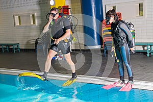 Scuba diving course pool teenager girl with instructor on the waterfront for
