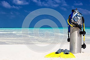 Scuba diving equipment on a tropical beach