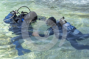 Scuba Diving Instructor Teaching a Little Boy to Dive