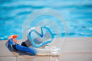Scuba diving mask nearl swimming pool on vacation at resort. Summer sunny day