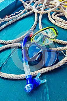Scuba diving and snorkeling. Two snorkel on blue wood Ship deck. The deck and the ship`s bow. The concept of sea voyage.