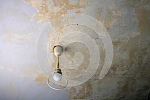 Scuffed ceiling with an old ceiling lamp