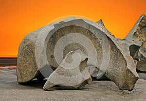 Sculpted rock formation and orange sky photo